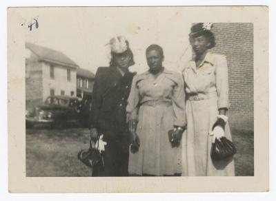 Three women holding hands
