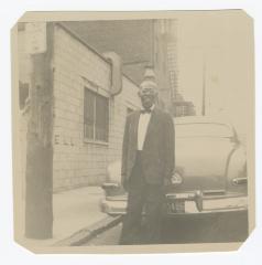 Man standing behind a car