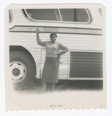 Friend of Sylvia Sparks posing in front of bus