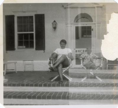 Woman and young boy sitting on a porch