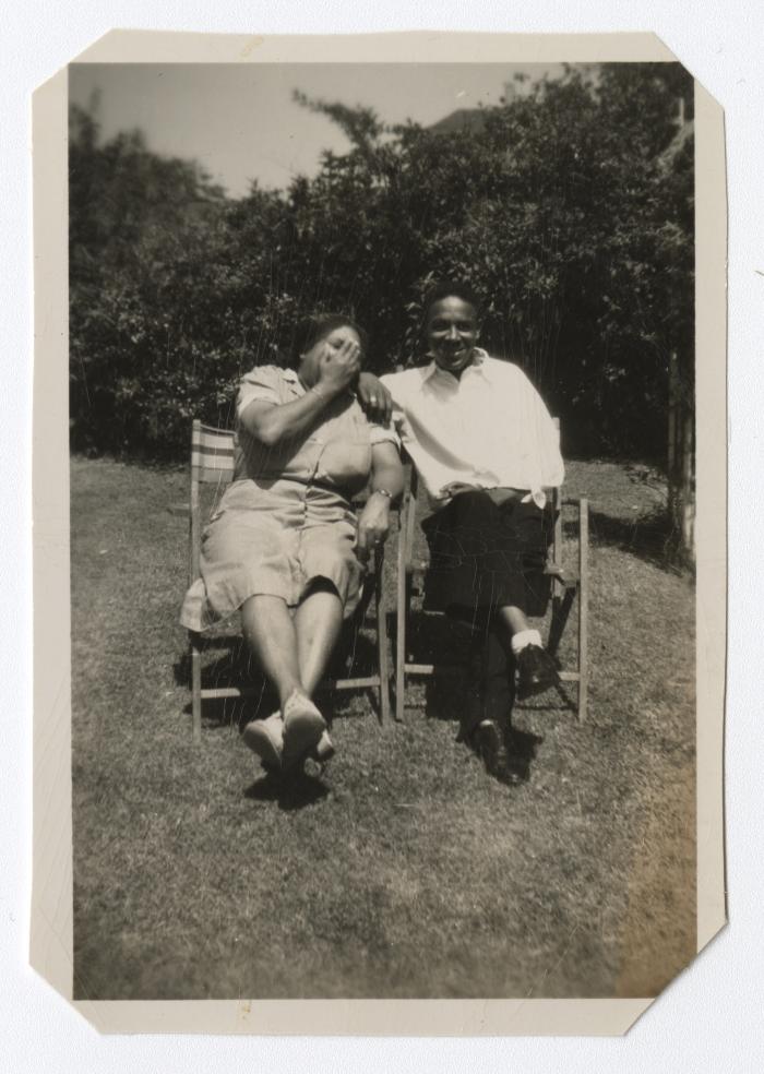 Man and woman sitting outdoors in chairs