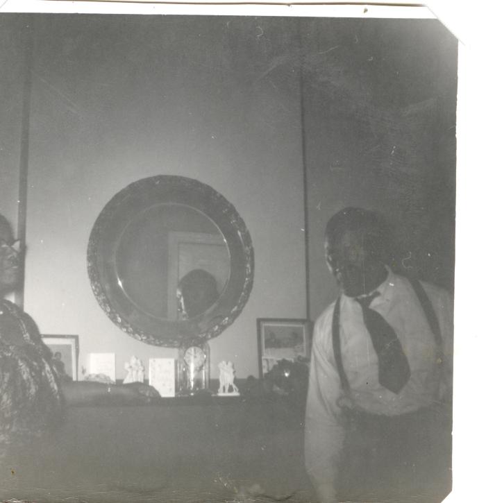 Man and woman standing before a fireplace