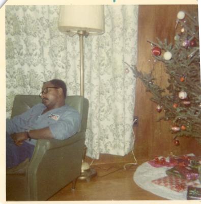 Man sleeping next to the Christmas tree
