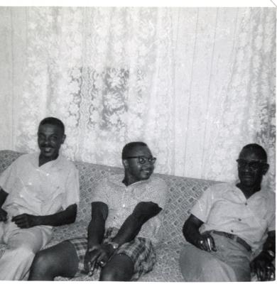 Three men sitting on a couch