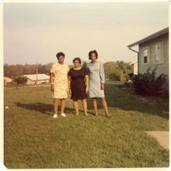 Three women in a yard