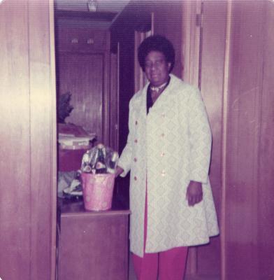 Woman standing with bucket of bottles