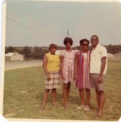 Group of four standing in the grass