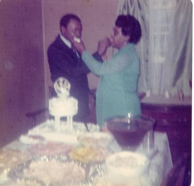 Newlyweds feeding each other cake