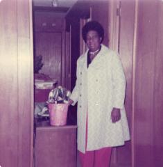 Woman standing with bucket of bottles