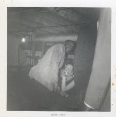 Three men and a woman in a basement