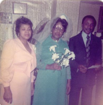 Woman standing with the bride and groom