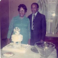 Bride and groom standing behind a cake