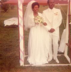 Bride and groom under the wedding arch