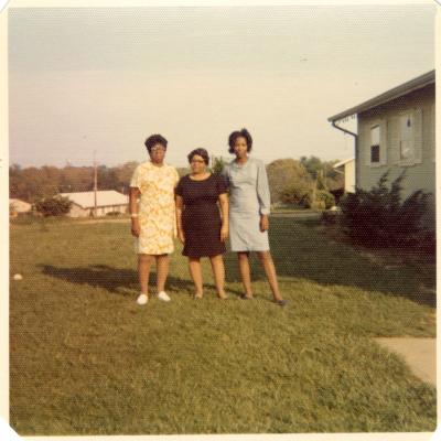 Three women in a yard