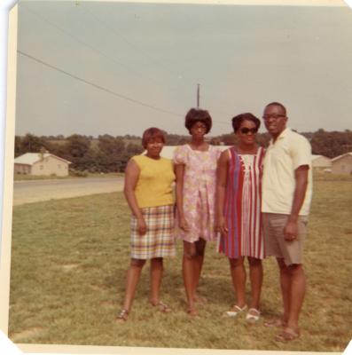 Group of four standing in the grass