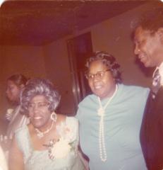 Three guests with their arms around one another