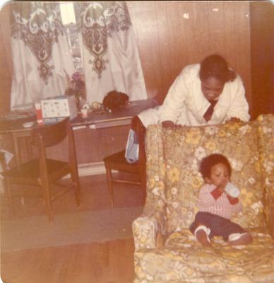 Child drinking a bottle on the couch
