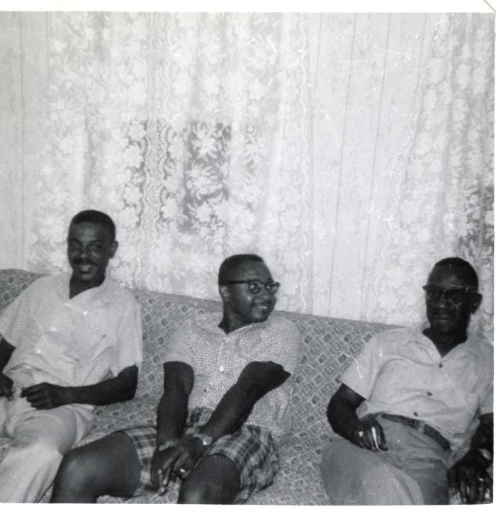 Three men sitting on a couch