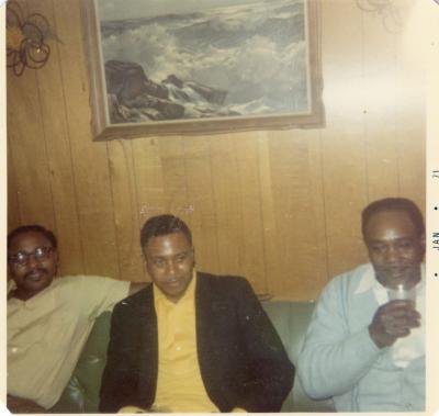 Three men sitting on a couch