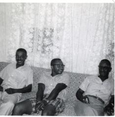 Three men sitting on a couch