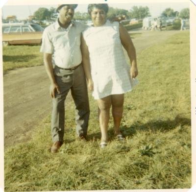 Man and woman in a grass parking lot