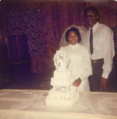Bride and groom with their wedding cake