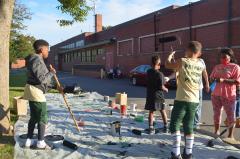 Young football players helping with the Black Lives Matter street mural
