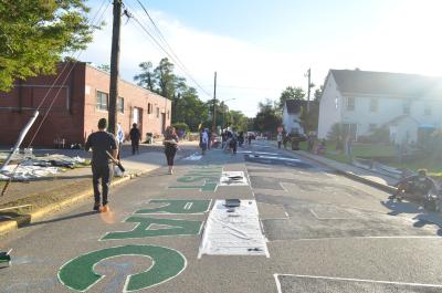The final stages of the painting of the Black Lives Matter street mural