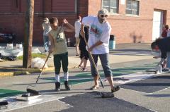Woman and young boy painting the Black Lives Matter street mural