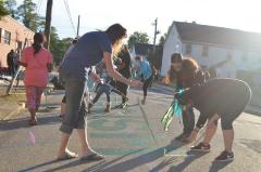 Women removing tape from the Black Lives Matter street mural