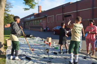 Young football players helping with the Black Lives Matter street mural