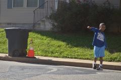 Young boy emulating the Black Lives Matter street mural fist