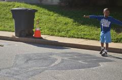 Young boy standing with Black Lives Matter mural