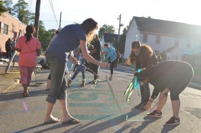 Women removing tape from the Black Lives Matter street mural