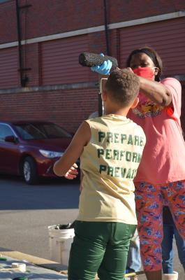 Young football player preparing a paint roller