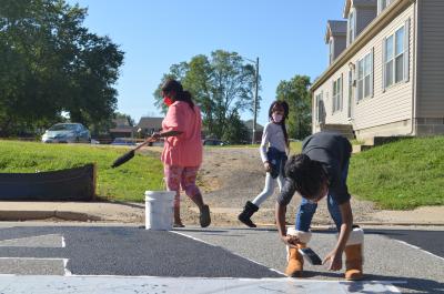 Children working on street mural