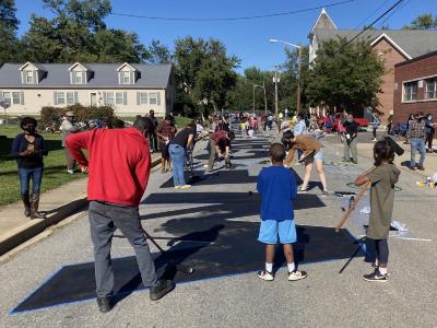 Community members painting "We Can't Breathe" street mural