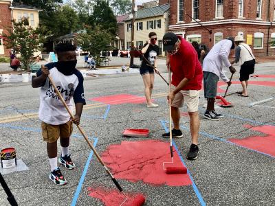 Community members painting the Black Lives Matter street mural with Mayor Chris Cerino