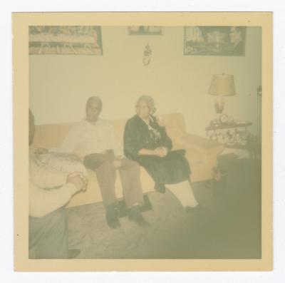 Three people talking in a living room