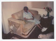 An older woman on a beige couch