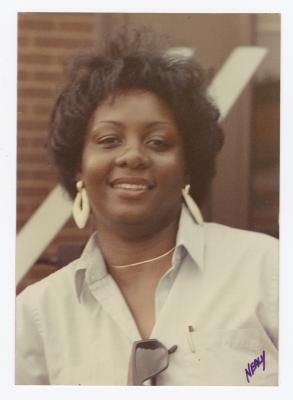A woman smiling outside