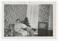 A man and a woman sitting on a couch in a living room