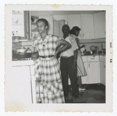 Three people cooking in a kitchen