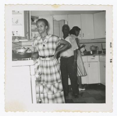 Three people cooking in a kitchen