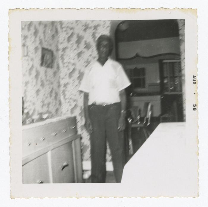 Blurry picture of a man in a dining room