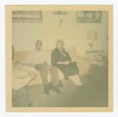 Three people talking in a living room