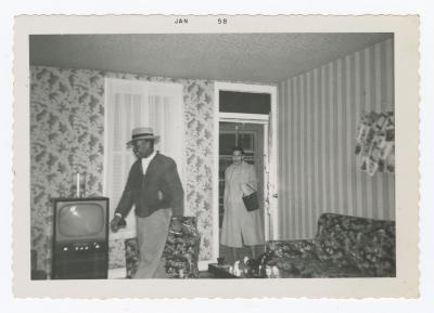 Two people entering a house