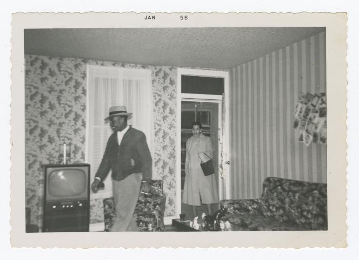 Two people entering a house