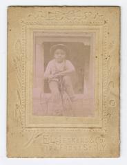 Framed picture of a young boy on a tricycle