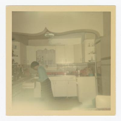 Woman looking in a kitchen drawer